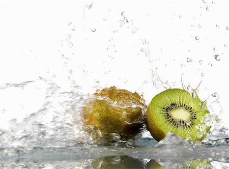 fruit splashing in water - Whole and half kiwi fruit with splashing water Stock Photo - Premium Royalty-Free, Code: 659-03533784