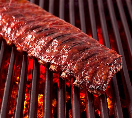 simsearch:659-06372574,k - Whole Rack of Pork Ribs on Grill with Barbecue Sauce Stock Photo - Premium Royalty-Free, Code: 659-03533799