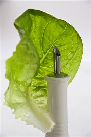 simsearch:659-07738887,k - A lettuce leaf with an oil bottle Stock Photo - Premium Royalty-Free, Code: 659-03533829