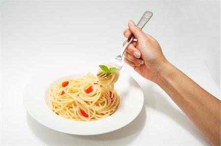 Person eating spaghettis Stock Photo - Premium Royalty-Free, Code: 652-05806739