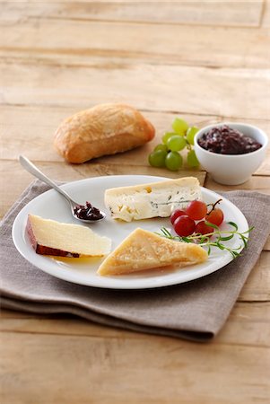 Plate of assorted Italian cheeses with grape jam Stock Photo - Premium Royalty-Free, Code: 652-05806852