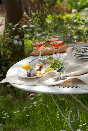 seafood white - Plate of grilled bass on a table outdoors Stock Photo - Premium Royalty-Free, Code: 652-05806956