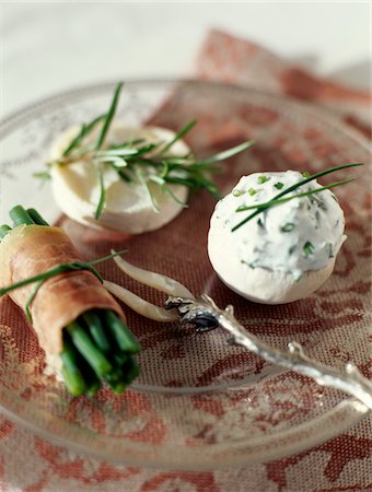 Mushroom top filled with cream cheese and chives,bundle of green beans wrapped in raw ham and small goat's cheese Stock Photo - Premium Royalty-Free, Code: 652-05807311