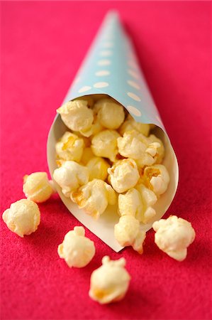 Sweet popcorn in a paper cone Stock Photo - Premium Royalty-Free, Code: 652-05807651
