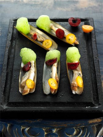 Razor clams with prunes,kumquats and fresh herb mousse Stock Photo - Premium Royalty-Free, Code: 652-05807916
