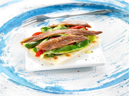 simsearch:825-06047693,k - Fresh anchovy,sliced red pepper and cucumber crisp bread open-sandwich Stock Photo - Premium Royalty-Free, Code: 652-05808007