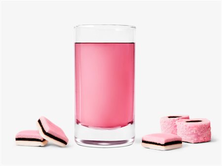 pink syrup - Glass of rose syrup and licorice candies Stock Photo - Premium Royalty-Free, Code: 652-05808233