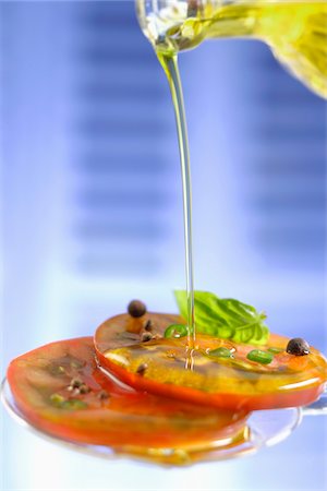 red pepper and basil - Pouring olive oil onto sliced tomatoes Stock Photo - Premium Royalty-Free, Code: 652-05808297