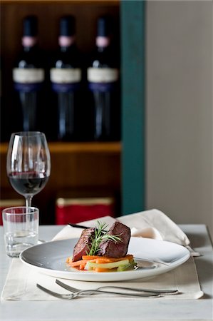 restaurant indoors nobody - Plate of beef steak with rosemary and vegetables in a wine bar Stock Photo - Premium Royalty-Free, Code: 652-05808580