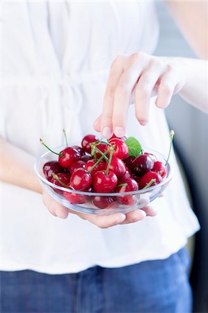 simsearch:652-03801709,k - Person carrying a bowl of cherries Stock Photo - Premium Royalty-Free, Code: 652-05808604