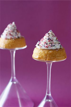 pastry display - Individual Rum Babas with whipped cream and colored sugar Stock Photo - Premium Royalty-Free, Code: 652-05808624