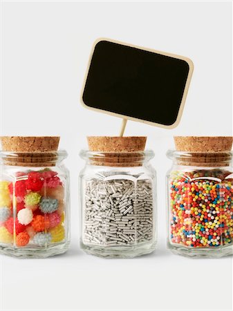 Small pots of sugar vermicellis and colored sugar drops for decorating cakes Stock Photo - Premium Royalty-Free, Code: 652-05808836