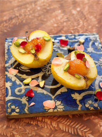 desserts with fruit sauces - Lebanese-style apples filled with apricots and ginger,rose and pistachio sauce Stock Photo - Premium Royalty-Free, Code: 652-05809029