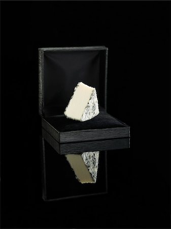 food box - Piece of goat's cheese in a jewellery box Stock Photo - Premium Royalty-Free, Code: 652-05809515