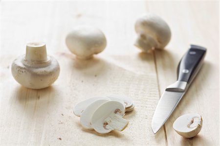 Thinly slicing the button mushrooms Stock Photo - Premium Royalty-Free, Code: 652-05809560