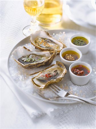 fine herb - Fresh oysters with three different flavored vinaigrettes Stock Photo - Premium Royalty-Free, Code: 652-06818829