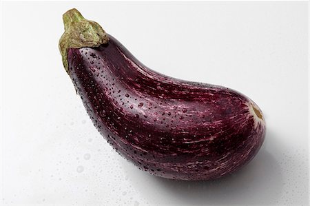 single aubergine - Striped eggplant on a white background Stock Photo - Premium Royalty-Free, Code: 652-06819191