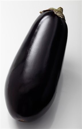 single aubergine - Eggplant on a white background Stock Photo - Premium Royalty-Free, Code: 652-06819192