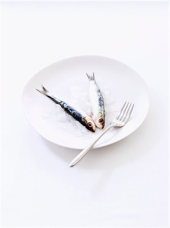 Two anchovies on a plate Stock Photo - Premium Royalty-Free, Code: 652-06819302