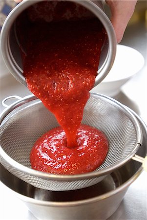pureed - Passing the stewed summer fruit through a sieve Stock Photo - Premium Royalty-Free, Code: 652-07656401