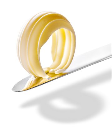Curly piece of butter on a knife Stock Photo - Premium Royalty-Free, Code: 652-07656426