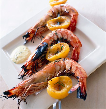 french foods appetizer - Gambas and apricot creole brochettes Stock Photo - Premium Royalty-Free, Code: 652-01667318