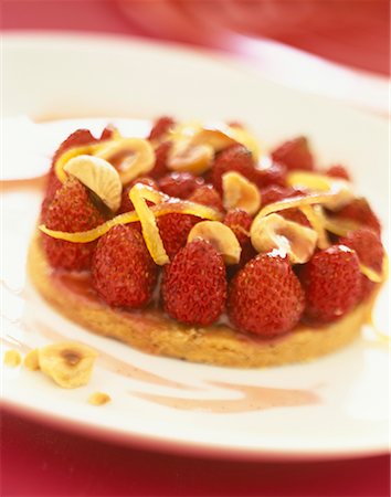 strawberry tartlet - Strawberry,hazelnut and orange zest confit tart Stock Photo - Premium Royalty-Free, Code: 652-02221531