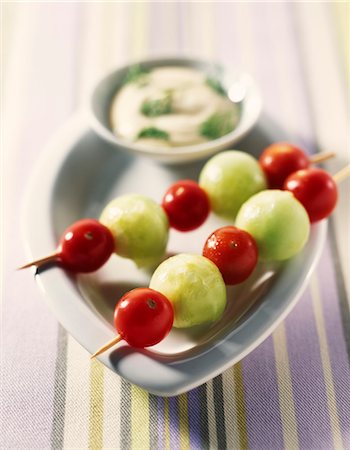 dipping sauces - Cucumber balls and cherry tomato brochettes with dip Stock Photo - Premium Royalty-Free, Code: 652-03635581