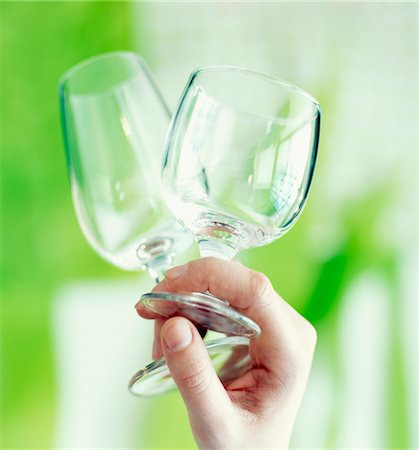 stemware - Two stemmed glasses in a hand Stock Photo - Premium Royalty-Free, Code: 652-03633370