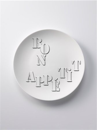 empty plate of food - Bon appétit written on a plate Stock Photo - Premium Royalty-Free, Code: 652-03804318