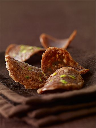 Chocolate and pistachio tuile biscuits Stock Photo - Premium Royalty-Free, Code: 652-03804350