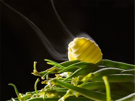 smoke on black background - Knob of butter on green beans Stock Photo - Premium Royalty-Free, Code: 652-03804438