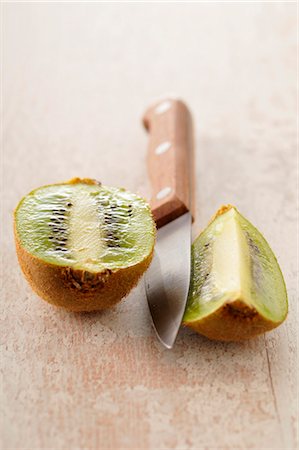 simsearch:652-07655937,k - Cutting a kiwi Stock Photo - Premium Royalty-Free, Code: 652-03804536