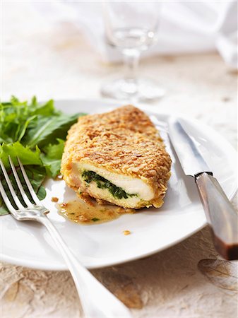 Chicken breast stuffed with herbs and cooked in breadcrumbs Stock Photo - Premium Royalty-Free, Code: 652-03804754