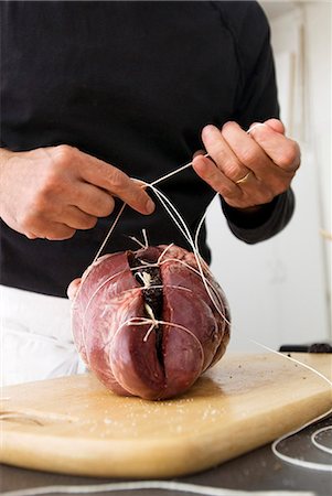 simsearch:652-02222448,k - Tying the stuffed heart with string Stock Photo - Premium Royalty-Free, Code: 652-03804791