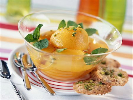 Poached peaches with fresh mint,pistachio tuile biscuits Stock Photo - Premium Royalty-Free, Code: 652-03800847