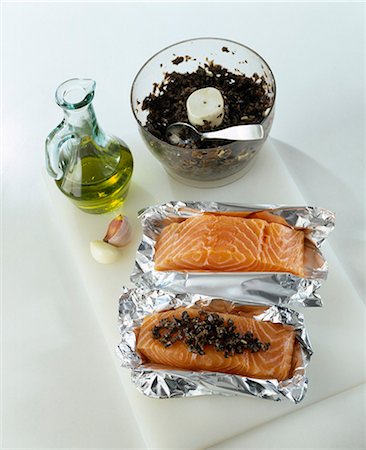 fish with olive oil - Spreading the tapenade on the pieces of salmon Stock Photo - Premium Royalty-Free, Code: 652-03801217