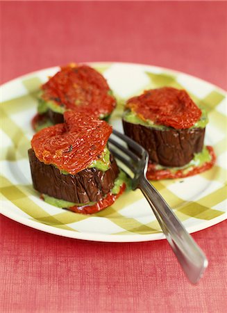 Sliced eggplant stuffed with greens and confit tomatoes Stock Photo - Premium Royalty-Free, Code: 652-03801729