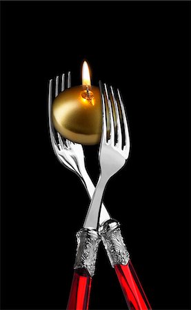 Two forks with golden candle ;candle light diner Stock Photo - Premium Royalty-Free, Code: 652-03802229