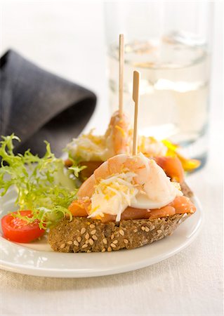 simsearch:652-03802601,k - Smoked salmon,egg and shrimp on a bite-size slice of bread Stock Photo - Premium Royalty-Free, Code: 652-03802596