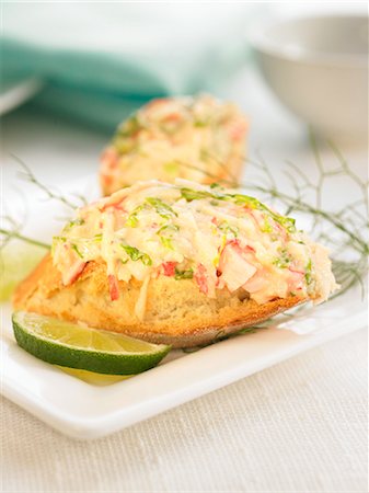 Crab salad on a bite-size slice of bread Stock Photo - Premium Royalty-Free, Code: 652-03802604