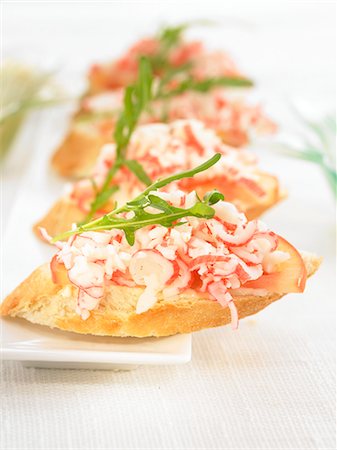 simsearch:652-03802601,k - King crab,tomato and rocket on a bite-size slice of bread Stock Photo - Premium Royalty-Free, Code: 652-03802635