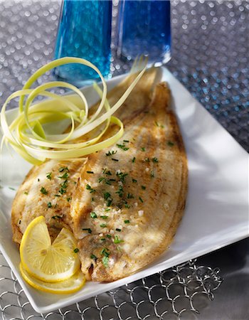 simsearch:825-05986458,k - Pan-fried soles with herbs and lemon Stock Photo - Premium Royalty-Free, Code: 652-03802980