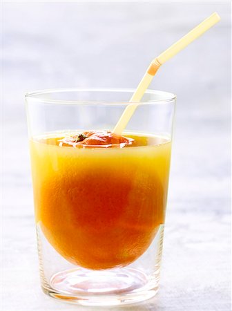 simsearch:825-06315120,k - Glass of orange juice with a straw Stock Photo - Premium Royalty-Free, Code: 652-03803013