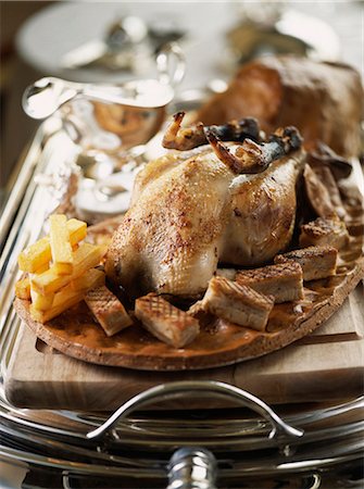 roast (cut of meat) - Roast chicken with chips on a silver trolley Stock Photo - Premium Royalty-Free, Code: 652-03803069