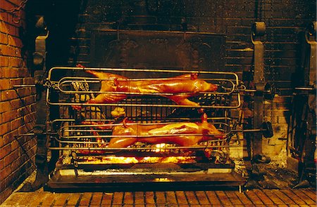 pig roast - Suckling pigs on the spit Stock Photo - Premium Royalty-Free, Code: 652-03803075