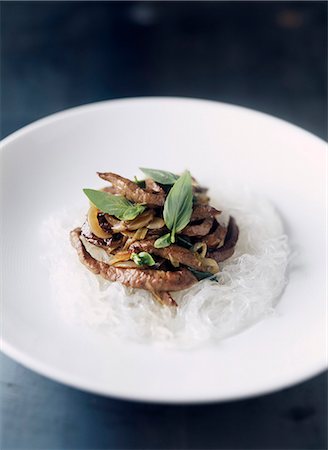 simsearch:652-03804849,k - Sliced beef with Thai basil on a bed of rice vermicelli Foto de stock - Sin royalties Premium, Código: 652-03803167