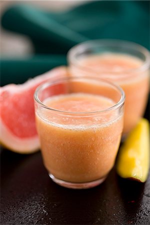 Grapefruit,banana and mango smoothie Stock Photo - Premium Royalty-Free, Code: 652-03803553