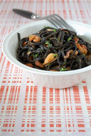 seafood pasta mussels shrimp - Squid ink tagliatelles with shellfish Stock Photo - Premium Royalty-Free, Code: 652-03803640