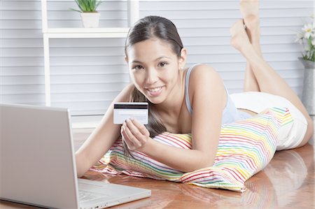 shopping japanese - Young woman enjoying online shopping Stock Photo - Premium Royalty-Free, Code: 669-05854488